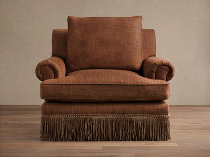 Front view of a brown McKinley Chair with Fringe, featuring rolled arms and a decorative fringed skirt.