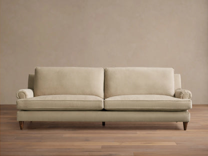 Front view of the oatmeal McKinley Sofa, featuring two large seat cushions, two plush back cushions, rolled arms, and dark wooden legs.
