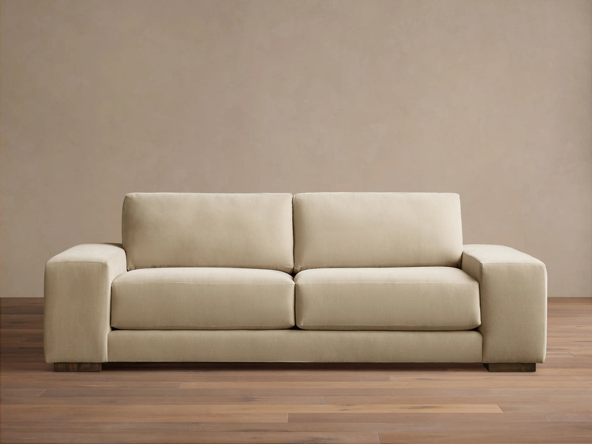 Front view of the beige Madson Sofa, featuring two plump seat cushions, two back cushions, and wide square arms.