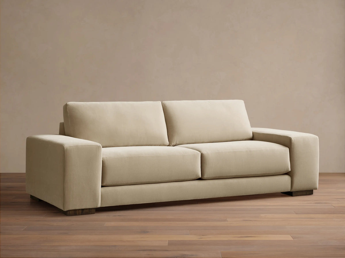 Front view of the beige Madson Sofa, featuring two plump seat cushions, two back cushions, and wide square arms.