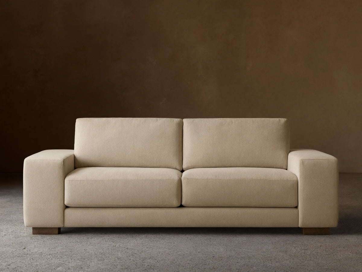 Front view of the beige Madson Sofa, featuring two plump seat cushions, two back cushions, and wide square arms.