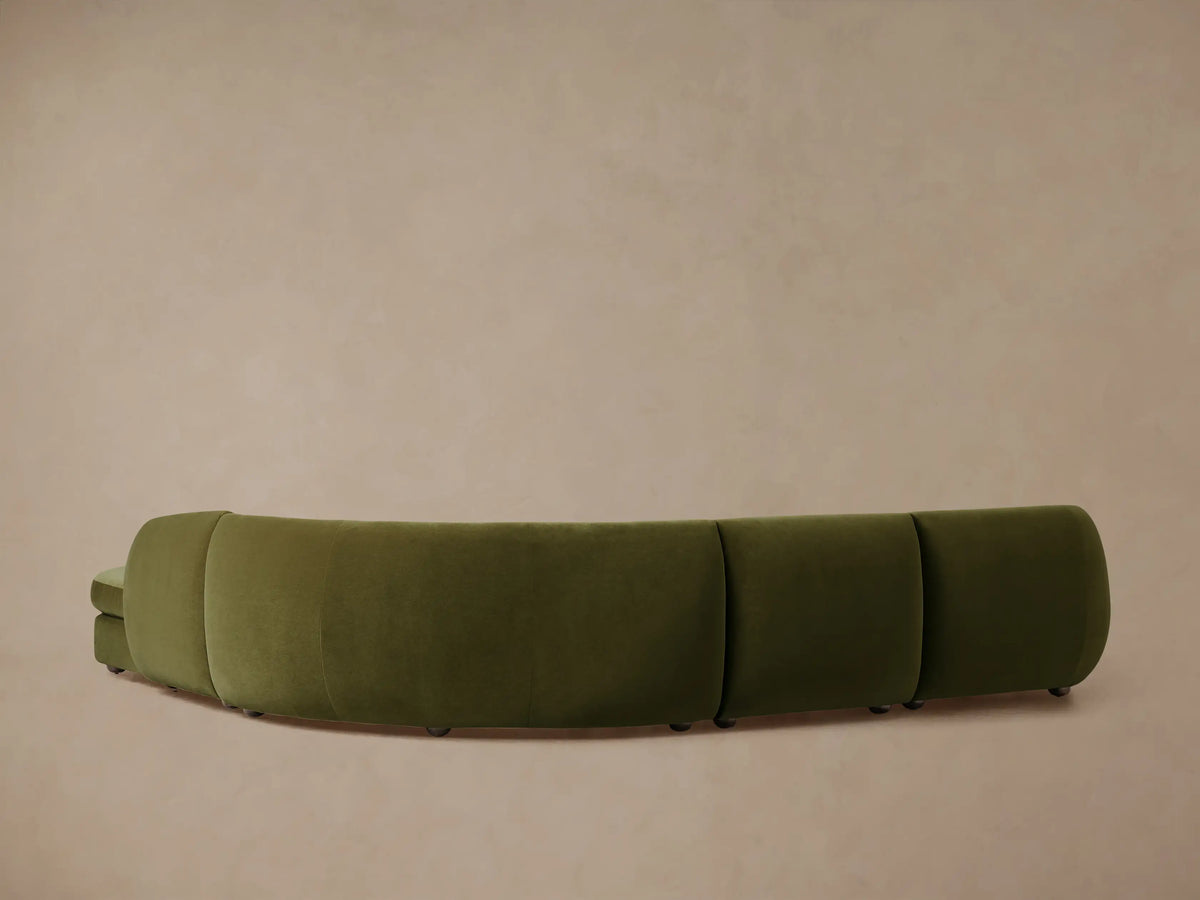 Milana Four-Piece Bumper Sectional in olive green, showing a curved design with plush upholstery, set against a neutral background.