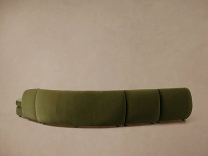 Milana Four-Piece Bumper Sectional in olive green, showing a curved design with plush upholstery, set against a neutral background.