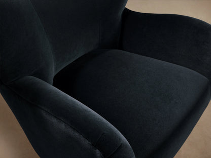 Front view of the Navy Myra Chair, an upholstered armchair with a high winged back, wide arms, and dark tapered wooden legs.