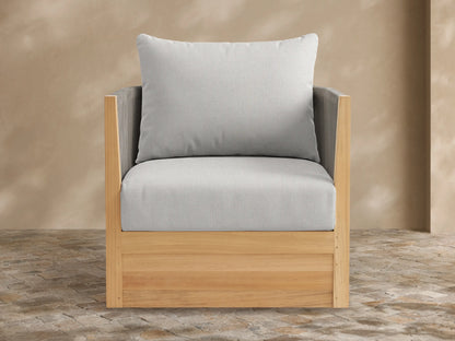 Newport Outdoor Swivel Chair with light teak frame and light grey cushions, front-facing on a patio against a beige wall.