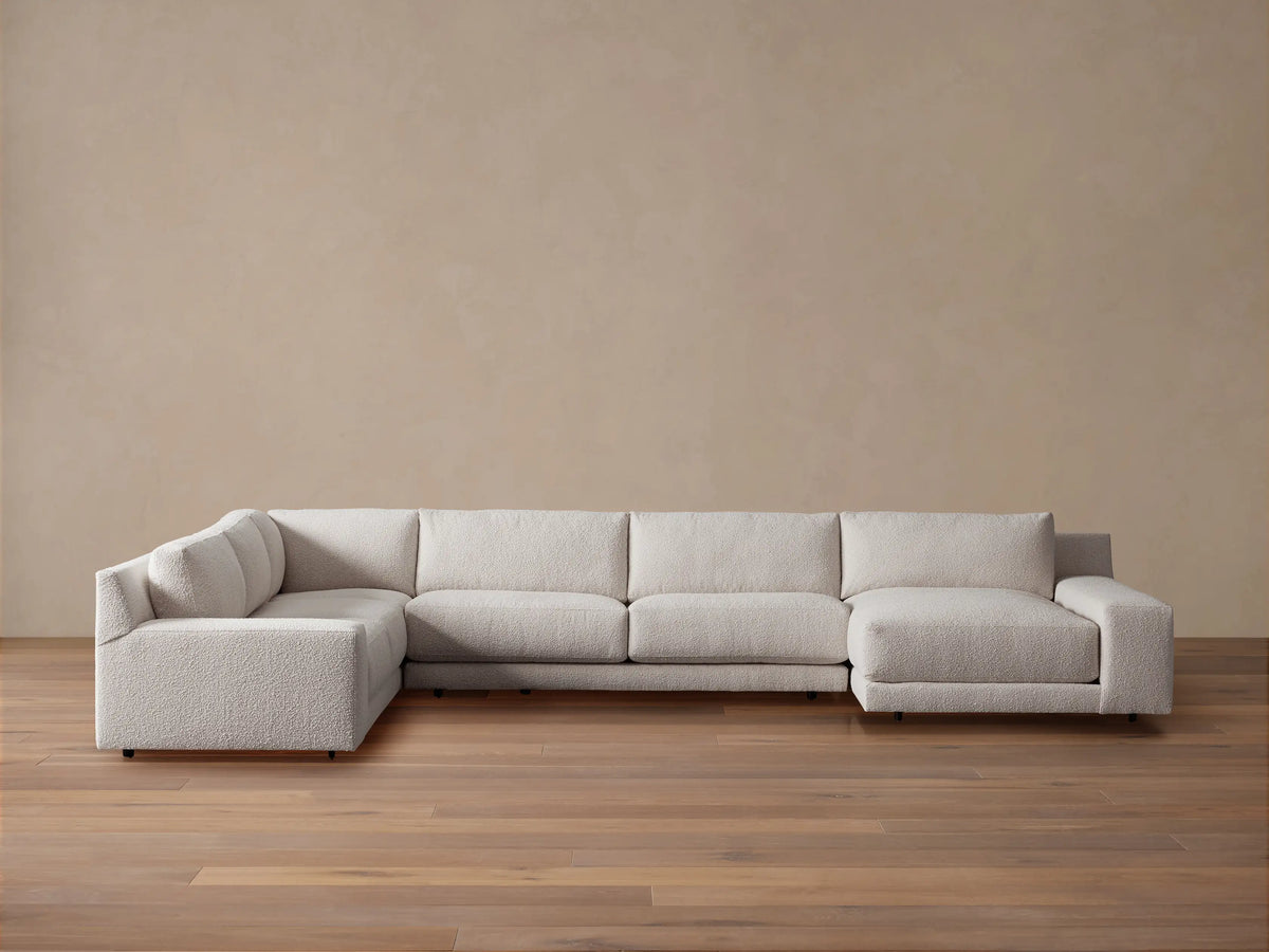 Novoli Four-Piece Chaise Sectional in textured light beige fabric, L-shaped with a right-facing chaise on a wood floor.