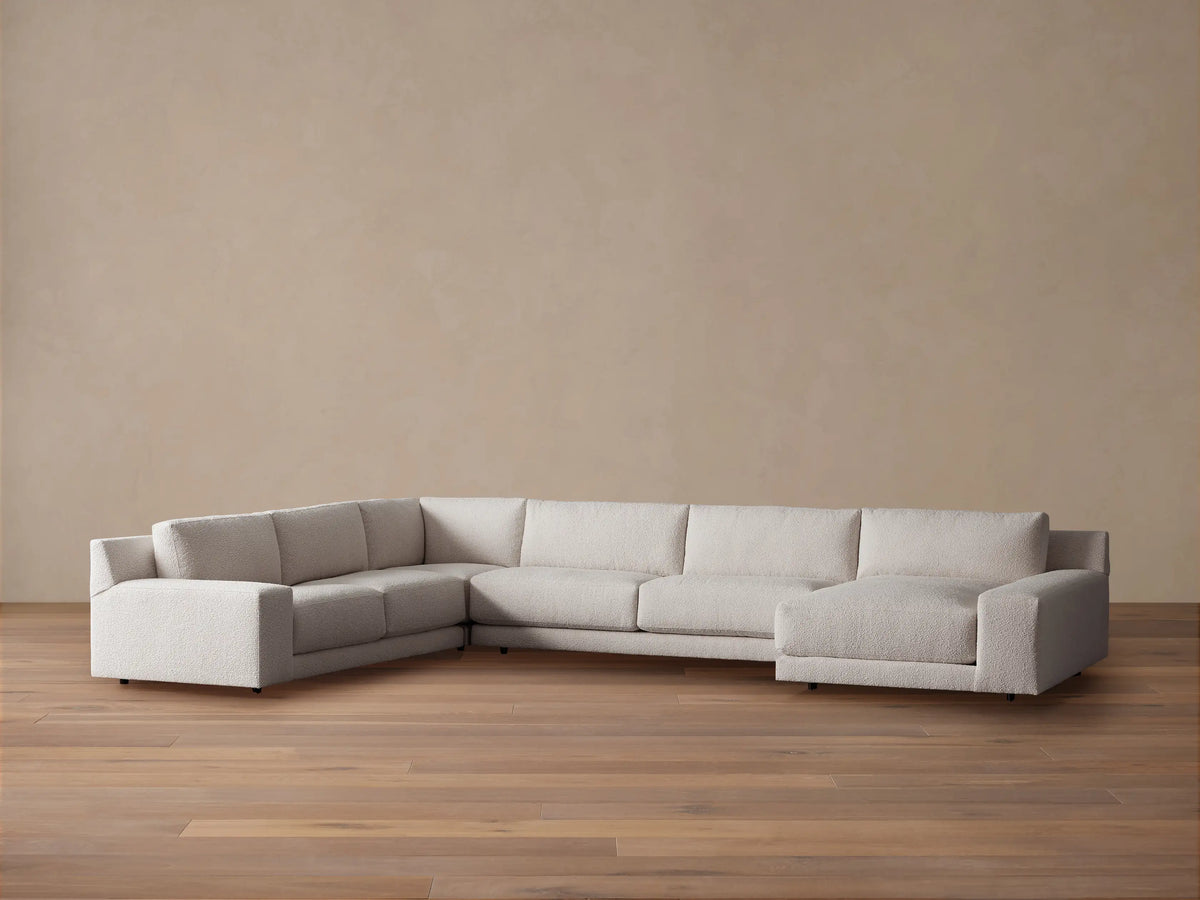 Novoli Four-Piece Chaise Sectional in textured light beige fabric, L-shaped with a right-facing chaise on a wood floor.