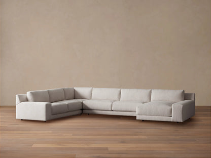 Novoli Four-Piece Chaise Sectional in textured light beige fabric, L-shaped with a right-facing chaise on a wood floor.