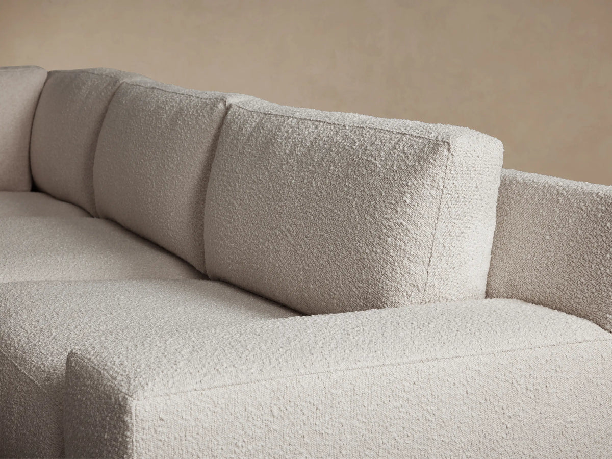 Novoli Four-Piece Chaise Sectional in light cream textured fabric, L-shaped with a left-facing chaise, on wood floor.