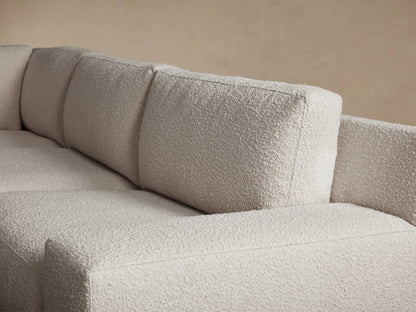 Novoli Four-Piece Chaise Sectional in light cream textured fabric, L-shaped with a left-facing chaise, on wood floor.