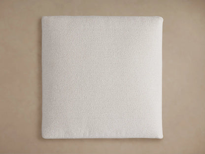 Light beige textured Novoli Ottoman, showing distinct cushions in a bouclv©-like fabric on a warm background.