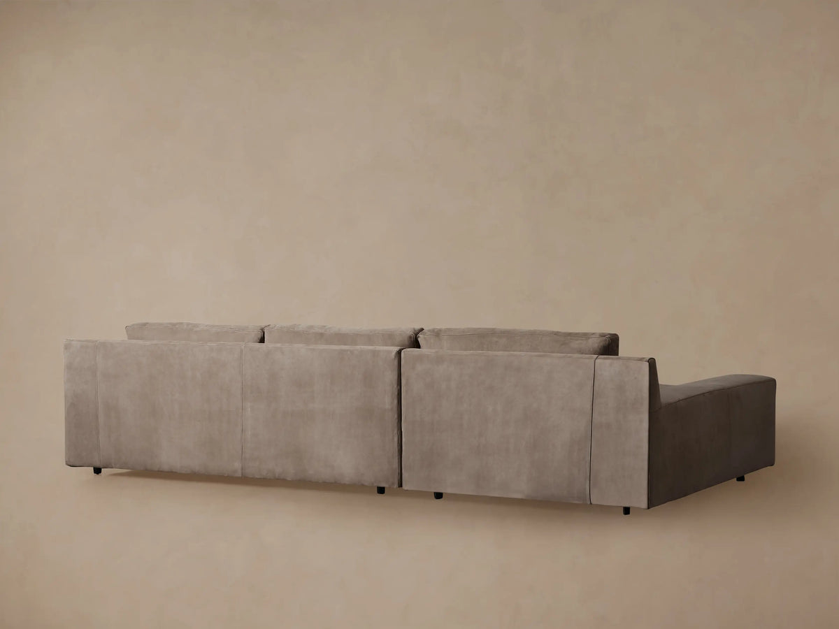 Novoli Nubuck Leather Two-Piece Chaise Sectional, close-up of warm brown nubuck leather, armrest, and back cushion with visible stitching.