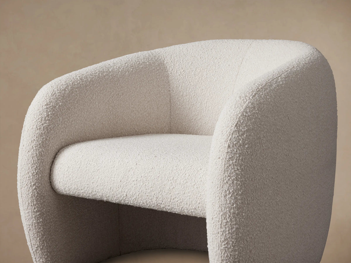 Fresno Floating Seat Chair, front. Cream bouclv© fabric, rounded continuous form, appears to float on a wood floor.