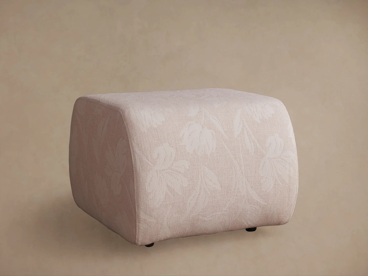 Front-side view of a beige, brown, and grey woven checkerboard patterned Fresno Ottoman with soft corners.