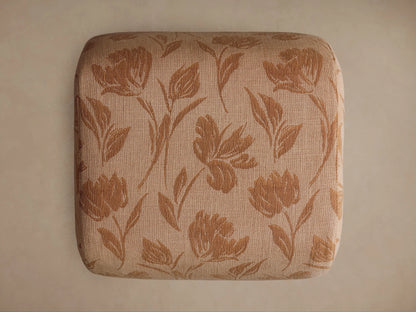 Close-up of Fresno Ottoman's light tan woven fabric with a darker brown, textured botanical leaf and floral pattern.