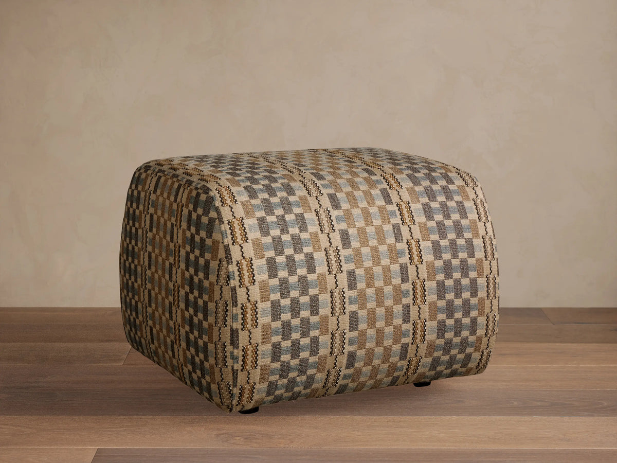 Front view of a square Fresno Ottoman with a woven geometric pattern in beige, white, and dark brown.