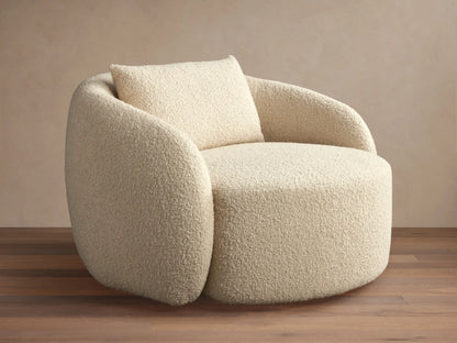 Fresno Oversized Swivel Chair in a creamy beige textured fabric, features a rounded back and plush seat with a matching pillow, set on wood floor.