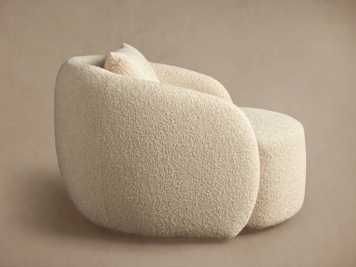 Fresno Oversized Swivel Chair in cream fabric, showcasing textured upholstery, rounded armrests, and a plush cushion.