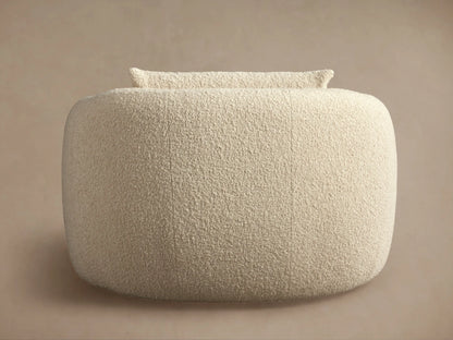 Fresno Oversized Swivel Chair in beige fabric, shown from the back, highlighting its curved, plush design on a neutral background.