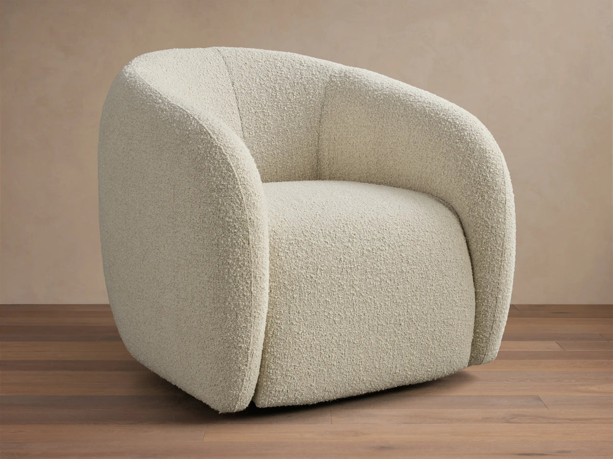Front view of the cream boucle Fresno Swivel Glider with a curved back and arms.