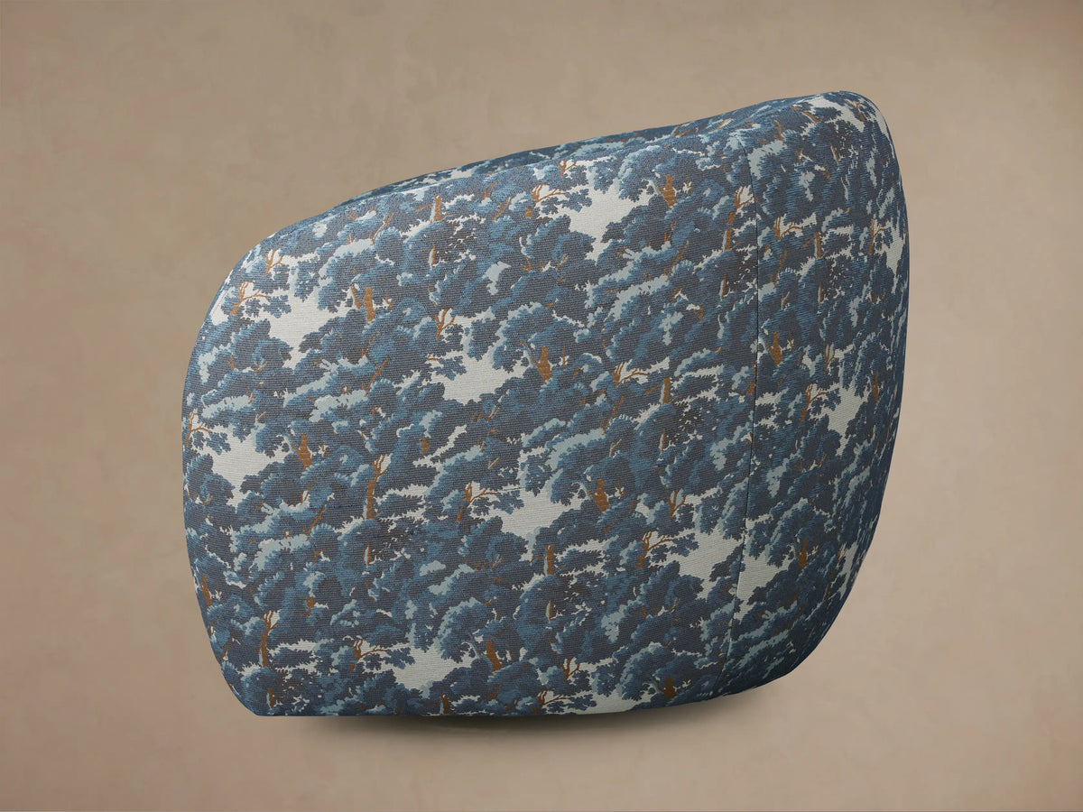 Close-up, top-down view of Fresno Swivel Chair in Oaks Pacific fabric, featuring dense blue and brown tree pattern.