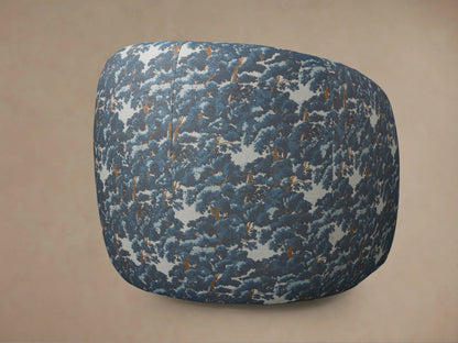 Fresno Swivel Chair upholstered in Oaks Pacific, a blue & white tree pattern fabric, with rounded silhouette, side view.