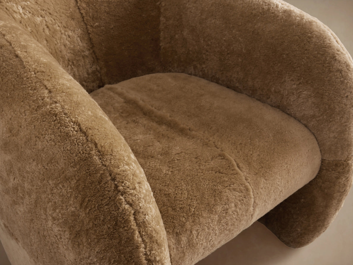 Fresno Shearling Floating Seat Chair in a plush, taupe shearling fabric. Curved backrest and seat cushion, showcasing soft texture.