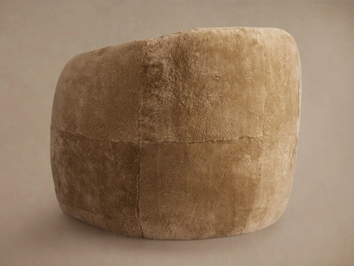 Fresno Leather Floating Seat Chair in brown plush fabric, showcasing its curved armrests, seat cushion, and soft texture.