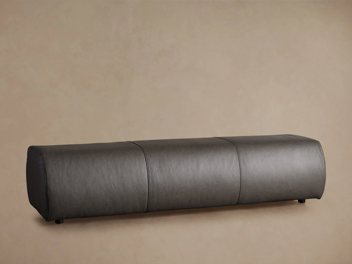 Fresno Leather Bench featuring a sleek, rectangular design with dark leather upholstery in a neutral setting on wooden flooring.