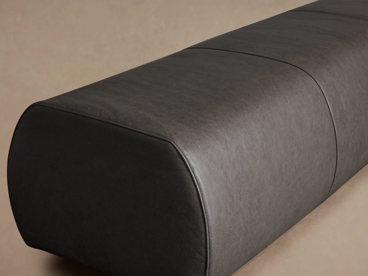 Fresno Leather Bench in dark brown leather, featuring a sleek, elongated shape with a smooth texture and rounded corners, set against a neutral background.