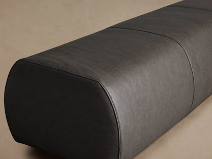 Fresno Leather Bench in dark brown leather, featuring a sleek, elongated shape with a smooth texture and rounded corners, set against a neutral background.