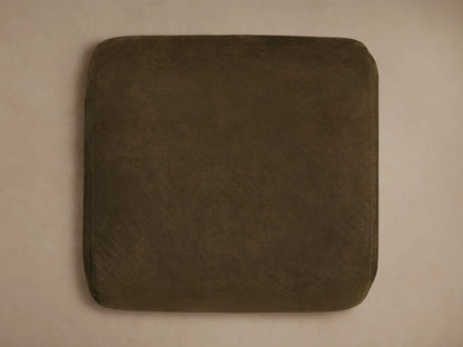 Close-up of the distressed brown embossed leather on the Fresno Leather Ottoman, showing a square pattern and light stitching.
