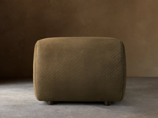 Front view of the dark olive green quilted Fresno Leather Ottoman with small dark feet.