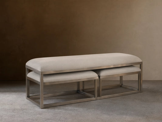 Palmer Upholstered Nesting Ottoman: Two white upholstered rectangular ottomans with bronze metal bases, one nested.