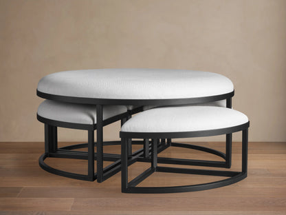 Palmer Round Nesting Ottoman set: large light grey upholstered main piece with four smaller ottomans nested inside, black metal.