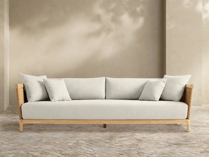 Front view of the natural teak Puglia Outdoor Teak Sofa‚Ñ¢ with light beige cushions and woven wicker sides.