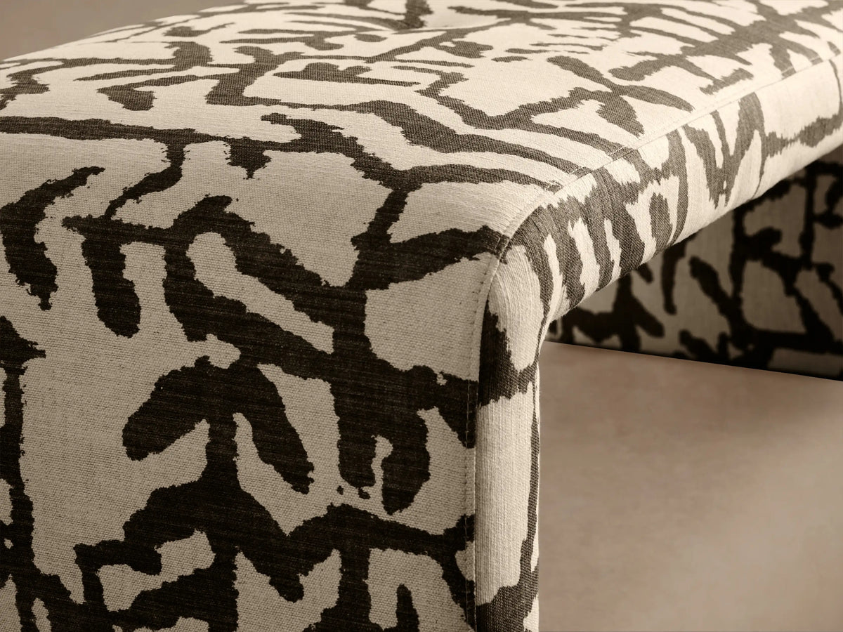 Ryan Bench upholstered in high-contrast black and white abstract pattern, viewed from front-right angle.