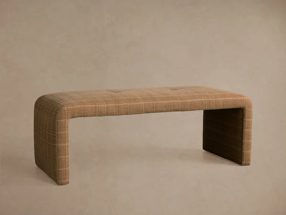 Ryan Bench, upholstered in light brown plaid fabric, angled view. Features a single tufted button and seamless waterfall design.