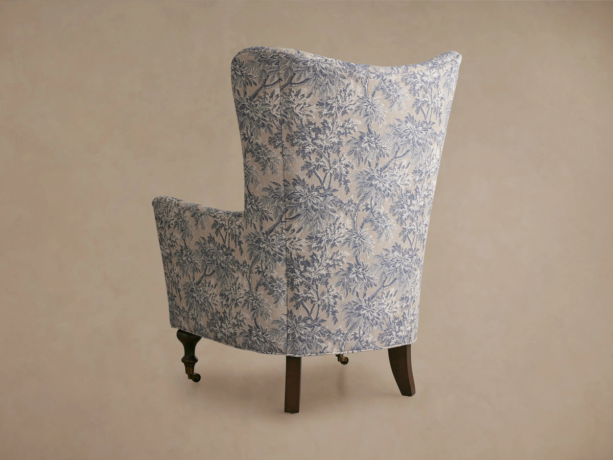 The Rio Chair features plush upholstery with a blue and beige floral pattern. It includes a soft, matching cushion for comfort.