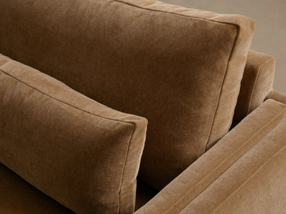 Sumner Two-Piece Bumper Sectional in tan fabric with a left-facing chaise. Features plush seat cushions, backrests, and a sleek design.