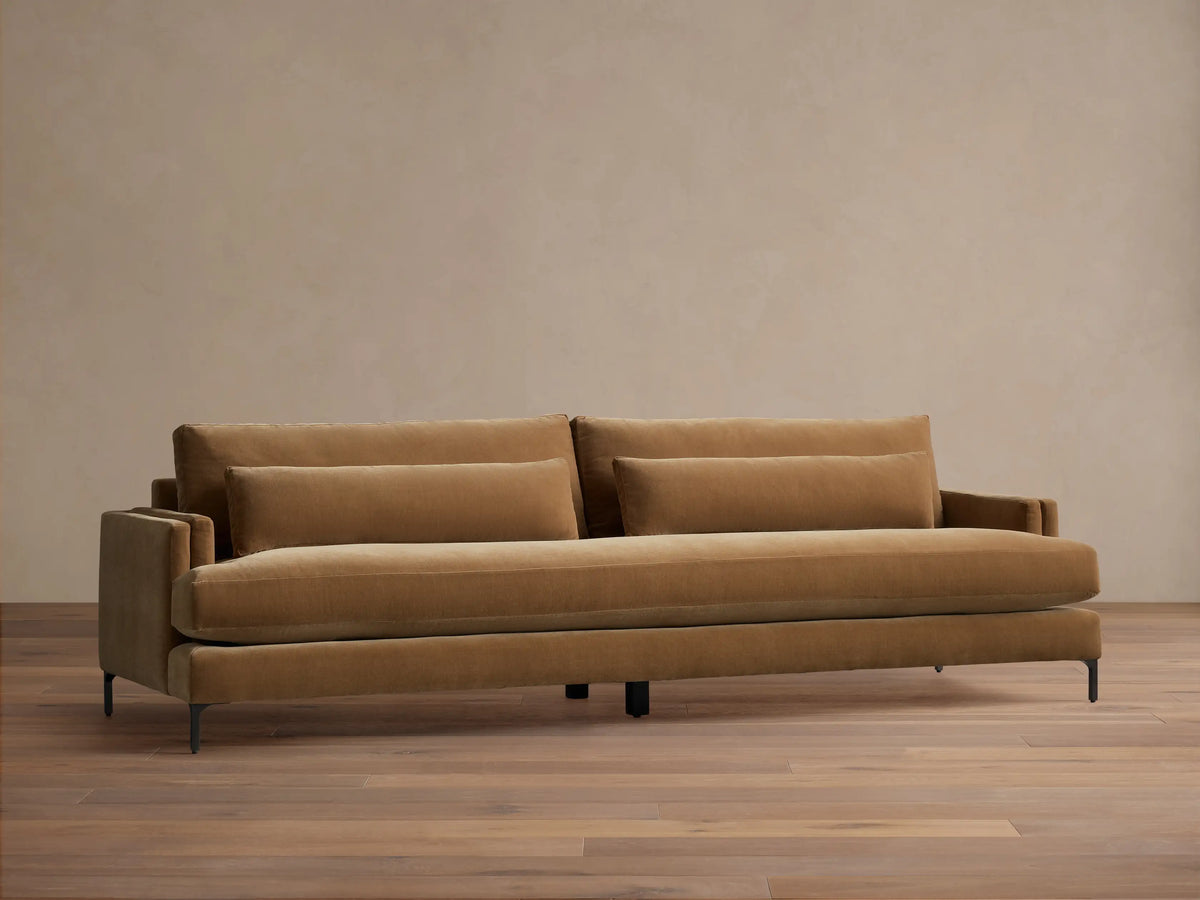 Front view of a Camel Sumner Sofa with plush cushions, two lumbar pillows, and sleek dark metal legs.
