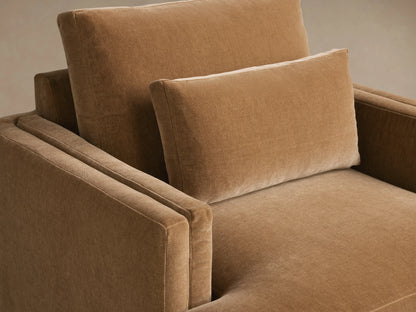 Sumner Swivel Chair in light brown fabric, front view. Features rectangular backrest, plush seat cushion, and padded armrests on wood floor.