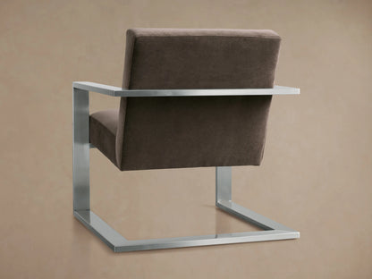 The Sabina Chair features a plush taupe cushion with a sleek metal frame. The thick cushion sits snugly between the metallic armrests.
