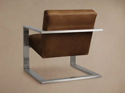 Close-up of the brown leather seat and armrest of the Sabina Leather Chair, with visible stitching and a silver metal frame.