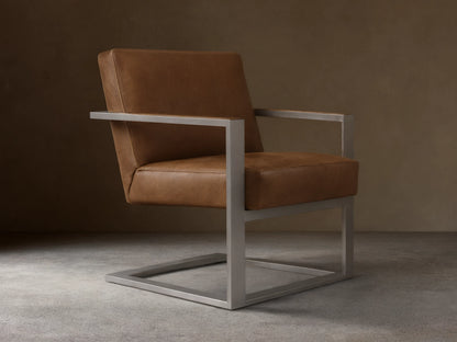 Front view of the brown Sabina Leather Chair, with rich brown leather cushions and a brushed silver-toned steel frame.
