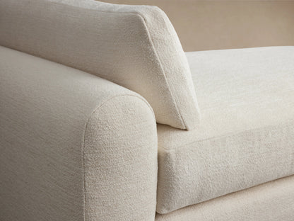 Sloane Daybed in cream-colored fabric with plush seat and back cushions, featuring a modern rectangular design against a neutral background.