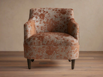 Savannah Chair, floral upholstery in light beige & rusty orange, dark tapered legs, front-right view on wood floor.
