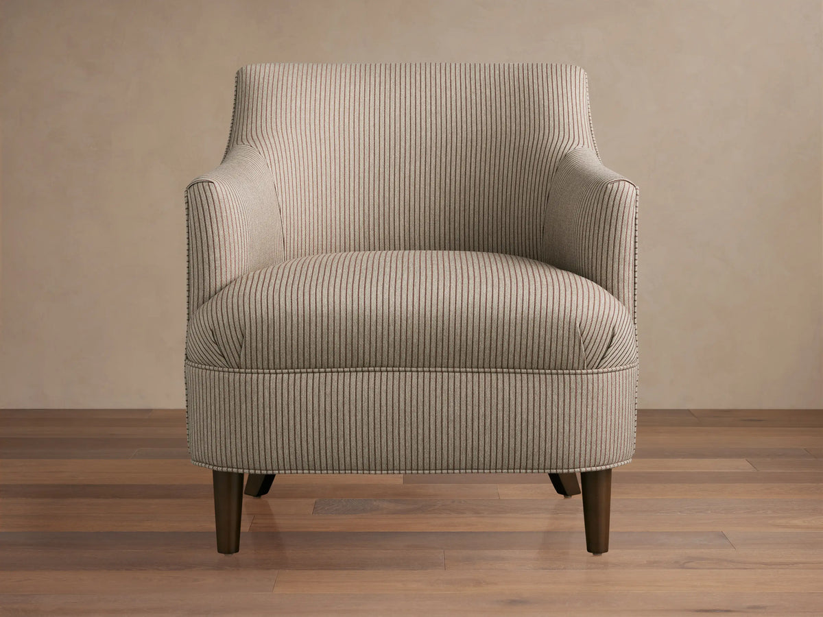 Savannah Chair: greige fabric armchair with thin dark vertical stripes, dark tapered legs, angled on a wooden floor.