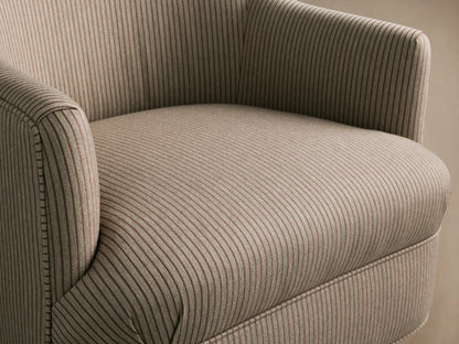 Savannah upholstered armchair in light beige fabric with fine dark vertical stripes, curved arms, nailhead trim, and dark wooden tapered legs.