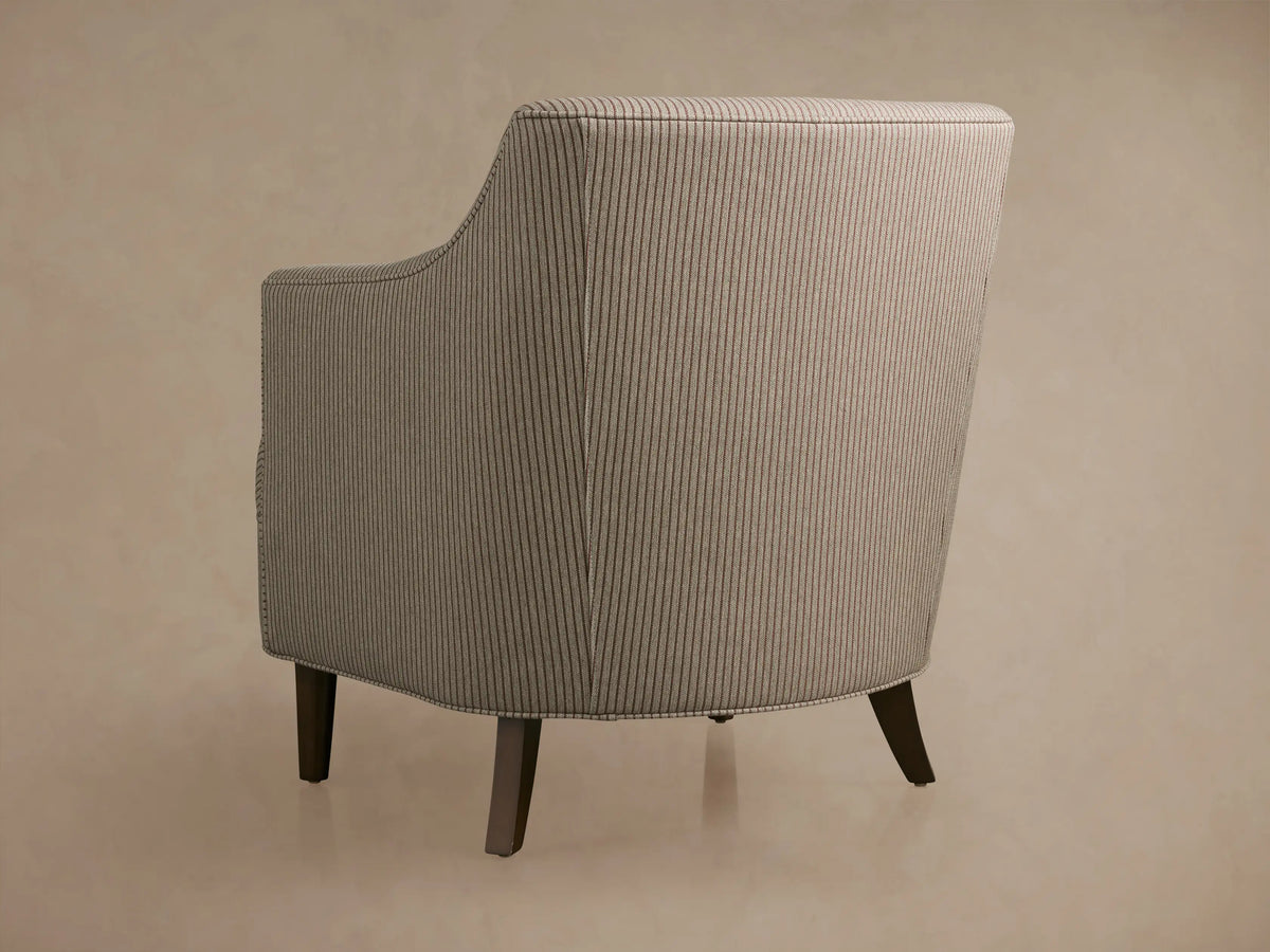 Close-up of Savannah Chair's seat & armrest, upholstered in light beige fabric with thin reddish-brown pinstripes.